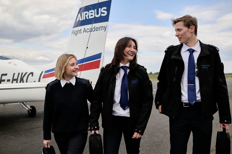 AFA - Group of cadets on tarmac 2 Three cadets laughing on Angoulême's airport tarmac with a Cirrus SR20 Airbus Flight Academy aircraft in the background