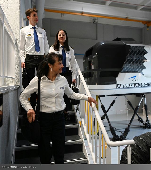 AFA - Cadets touring the Training Center Cadets touring the Airbus Europe Training Center with an instructor, passing the A350 FFS