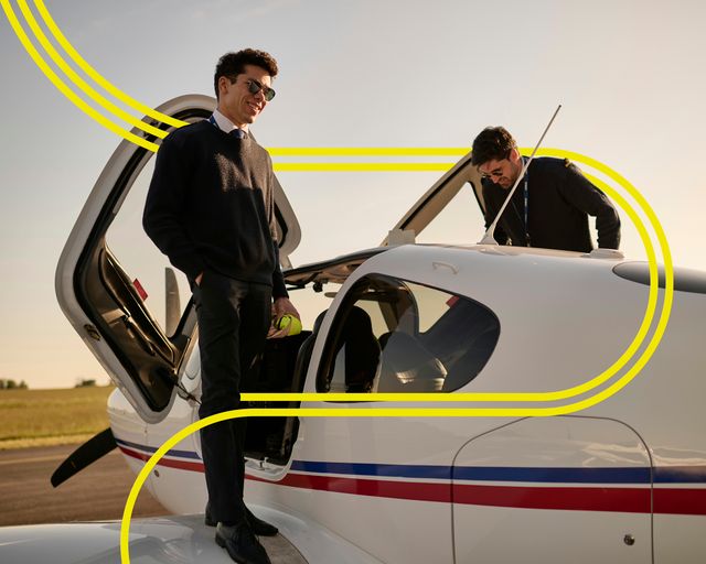 AFA -Two cadets beside a small aircraft with stripes Two cadets on the wings of an Airbus Flight Academy aircraft in the sun, preparing to go in the aircraft