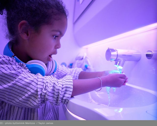 Child in lavatory with touchless features in A330neo Airspace cabin Child in lavatory with touchless features in A330neo Airspace cabin