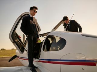 AFA - Two cadets beside an aircraft Two cadets on the wings of an Airbus Flight Academy aircraft in the sun, preparing to go in the aircraft