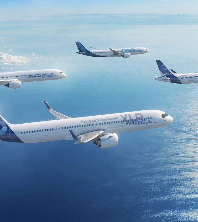 Airbus Family Aircraft  Airbus A220-300, A321XLR, A330-900, and A350-1000 in Airbus livery flying over the sea.