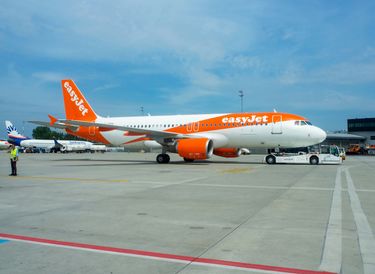 Airbus a320 passenger aircraft with a pushback tractor on Balice airport Airbus a320 passenger aircraft with a pushback tractor on Balice airport
