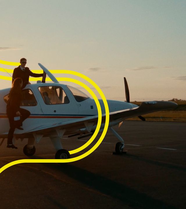 AFA - Cadets board a Cirrus SR20  with stripes Cadets board a Cirrus SR20 Airbus Flight Academy aircraft on Angoulême's airport tarmac at dusk