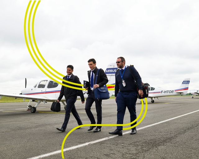 AFA - Instructor and cadets walking on tarmac with stripes AFA - Instructor and cadets walking on tarmac with stripes