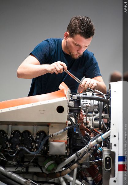 AFA - Maintenance of an engine A mechanic doing maintenance on the engine of an Airbus Flight Academy aircraft in a hangar on Angoulême's airport