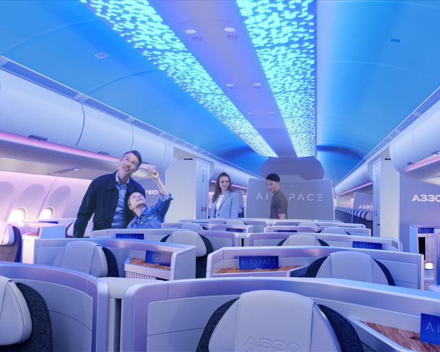 People looking at the hero light onboard the A330neo Airspace cabin. People looking at the hero light onboard the A330neo Airspace cabin.
