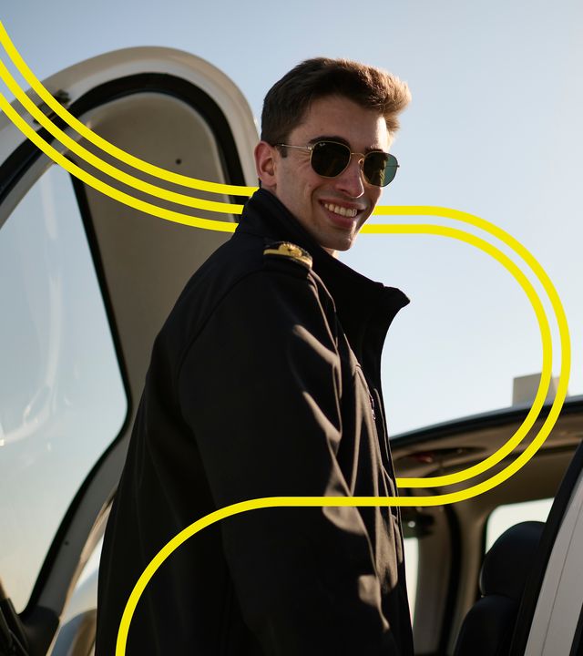 AFA - Cadet smiling by an aircraft 1 with stripes Smiling cadet on the wing of a Cirrus SR20 Airbus Flight Academy aircraft on sunny Angoulême's airport tarmac