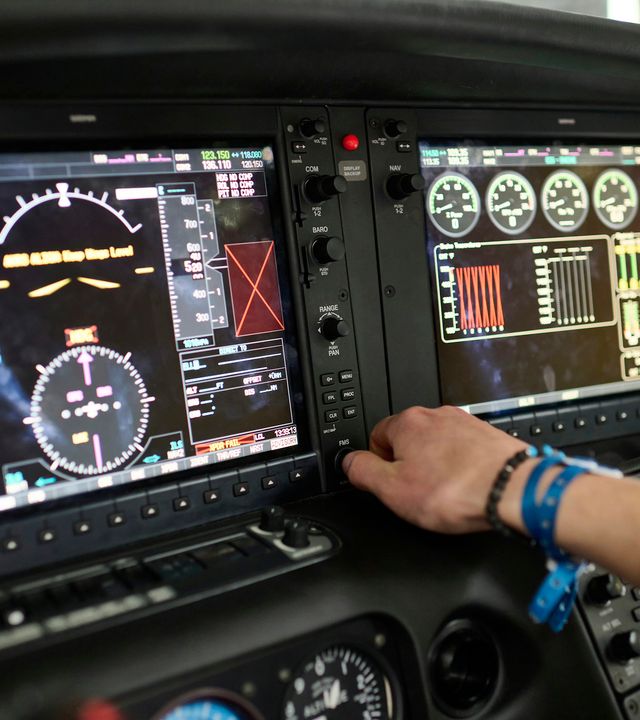 AFA - Cadet in cockpit Hand of a cadet manipulating avionics in the cockpit of a Cirrus SR20 AFA aircraft in Airbus Flight Academy Europe campus