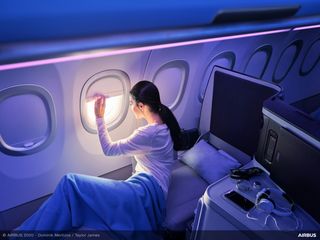 Passenger waking up from Full-flat comfort seat  in A320 Airspace cabin Passenger waking up from Full-flat comfort seat  in A320 Airspace cabin