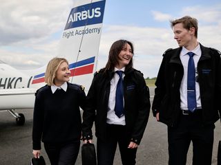 AFA - Group of cadets on tarmac 2 Three cadets laughing on Angoulême's airport tarmac with a Cirrus SR20 Airbus Flight Academy aircraft in the background