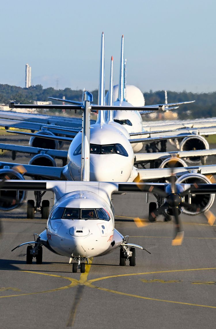 Airbus Family Flight Front view of Airbus aircraft, including A320, A330, and A350, lined up on the tarmac for a Family Day event.