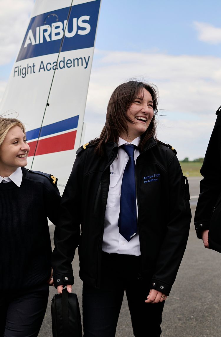 AFA - Group of cadets on tarmac 2 Three cadets laughing on Angoulême's airport tarmac with a Cirrus SR20 Airbus Flight Academy aircraft in the background