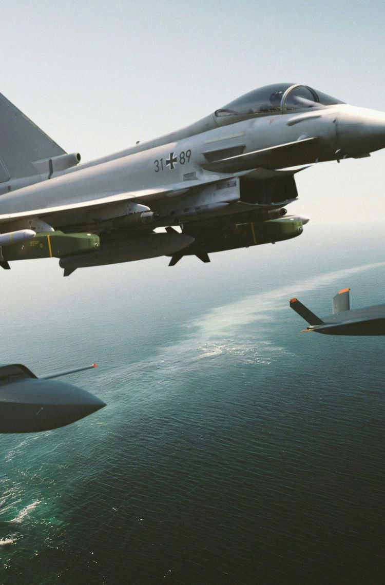Eurofighter with 2 XQ-58 over baltic maritime environment Eurofighter with 2 XQ-58 over baltic maritime environment