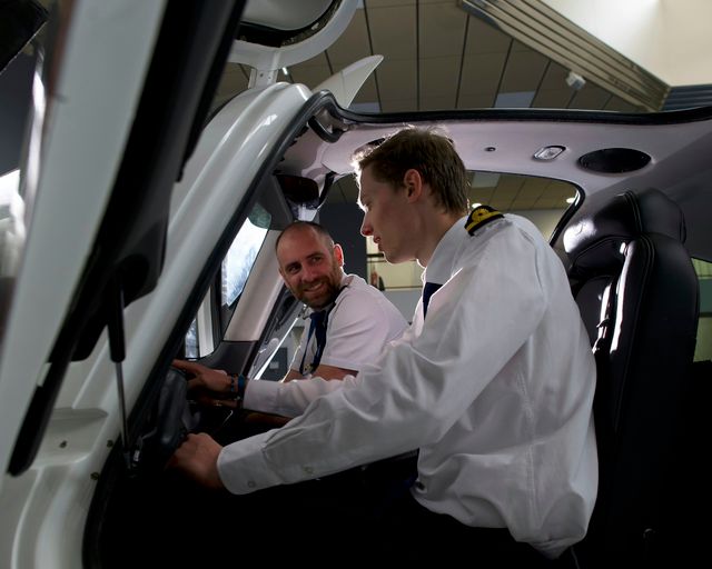 AFA Cadet with instructor in aircraft 1 An instructor is showing the cockpit to a cadet inside a Cirrus SR20 AFA aircraft in Airbus Flight Academy Europe campus