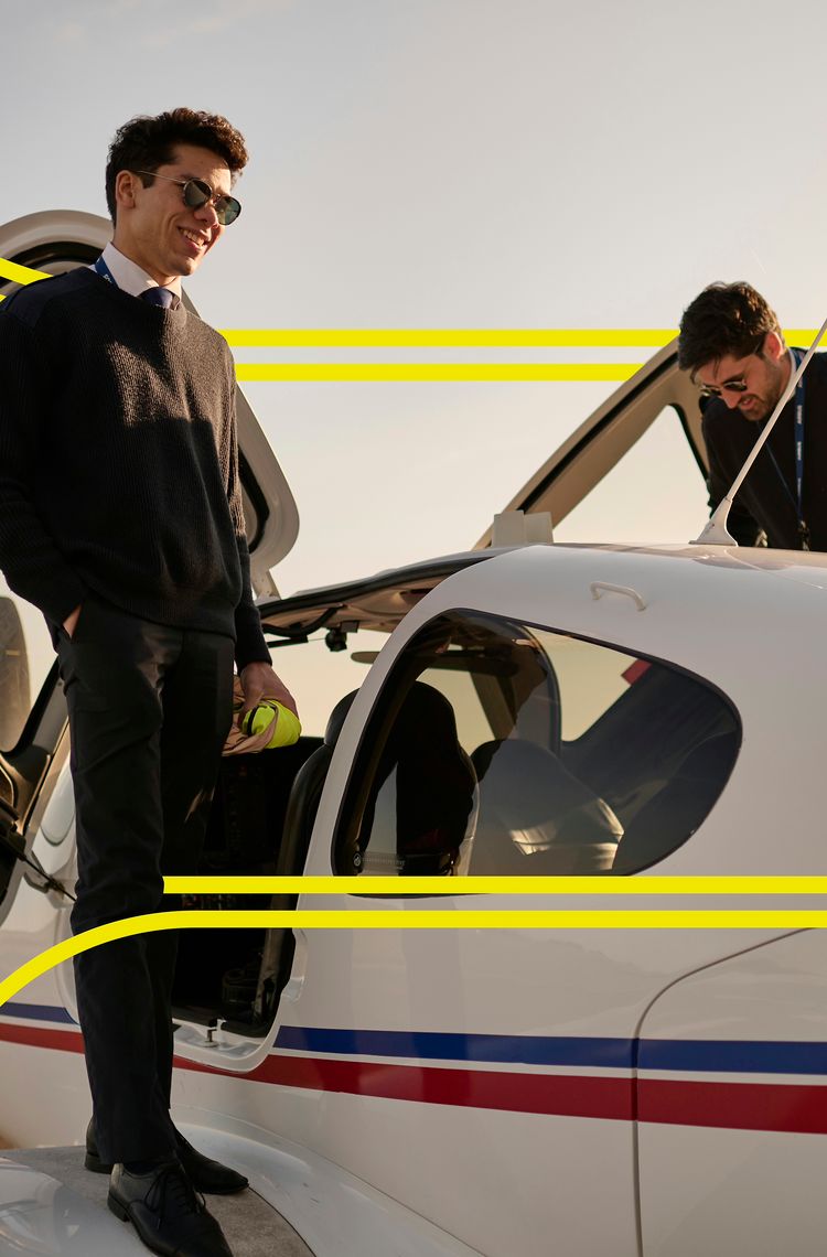 AFA -Two cadets beside a small aircraft with stripes Two cadets on the wings of an Airbus Flight Academy aircraft in the sun, preparing to go in the aircraft